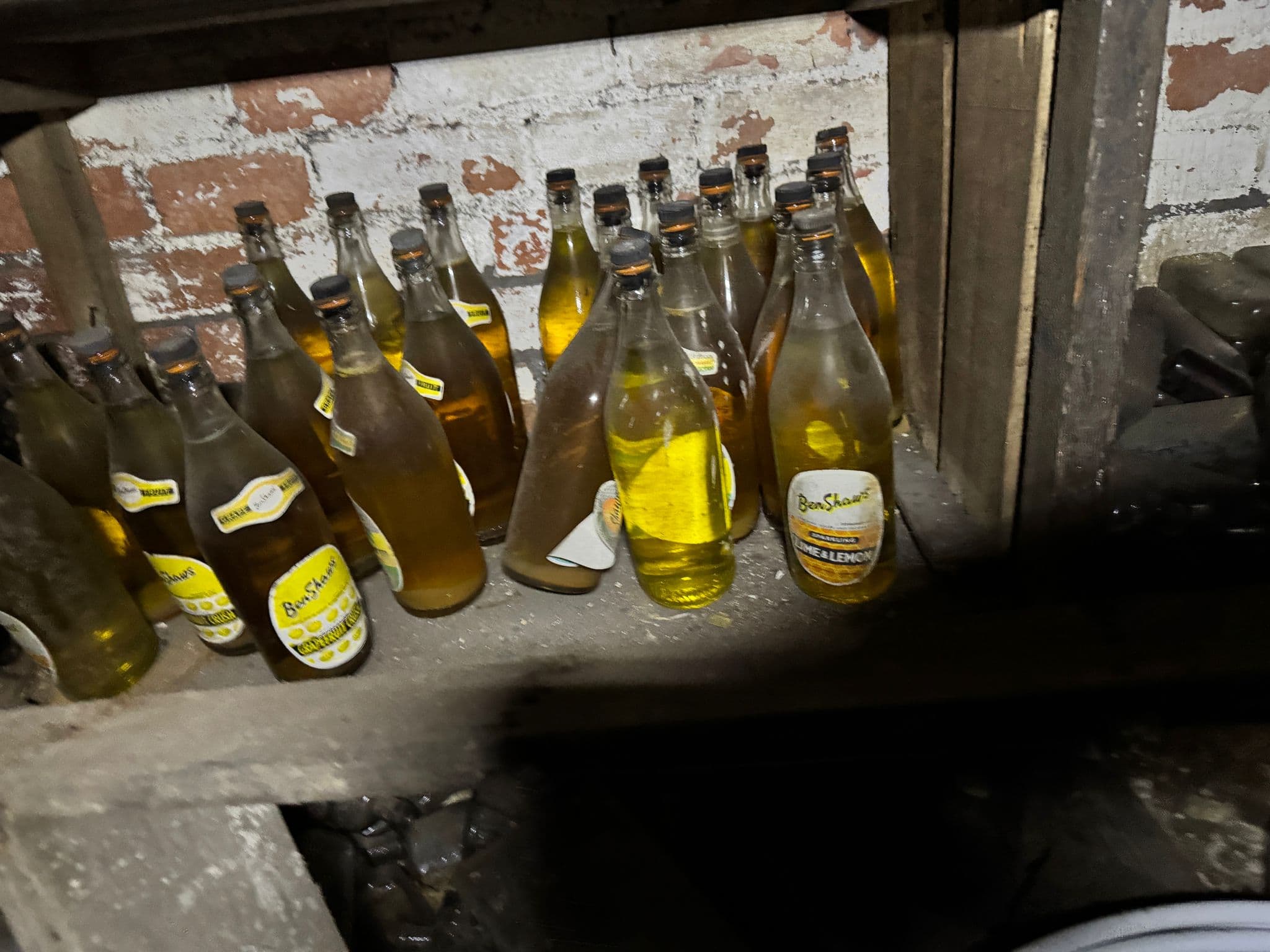 A stash of old glass bottles found beneath the floorboards